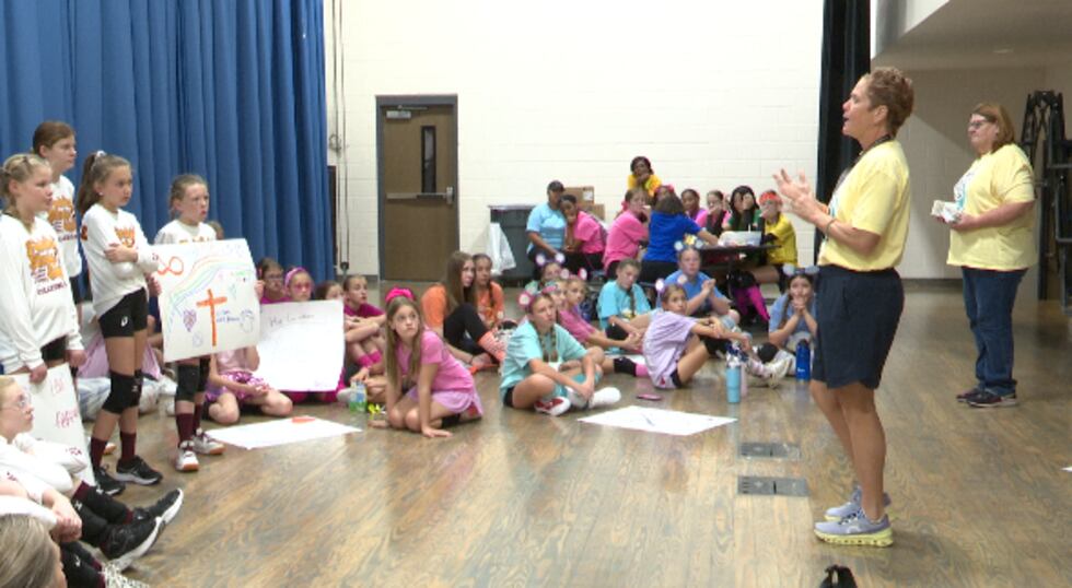 Jen Martinsen speaks to volleyball players during their "Huddle Time" at the annual Volley for...