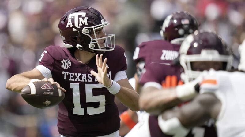Texas A&M quarterback Conner Weigman (15) throws down field against Auburn during the first...