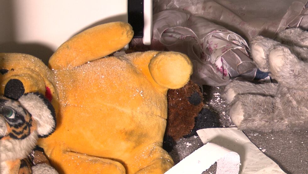 Toys like this teddy bear are now covered in ash and surrounded by drywall pieces after the...