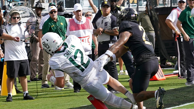 Baylor quarterback Blake Shapen (12) crosses the goal line in front of Central Florida...