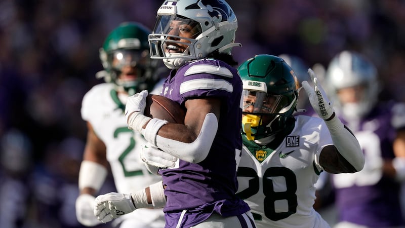 Kansas State running back DJ Giddens (31) is chased by Baylor safety Devyn Bobby (28) as he...