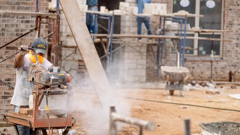 Workers build a new home in a Longview subdivision on Dec. 17, 2021.