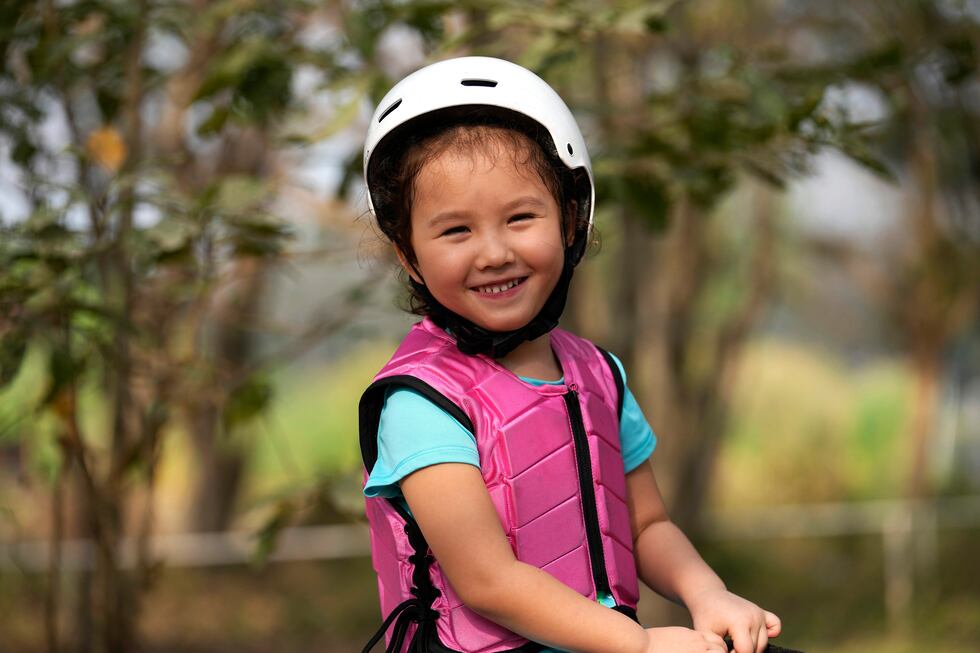 Rylae-Ann Poulin smiles as she learns to ride a horse in Bangkok, Thailand, Saturday, Jan. 14,...