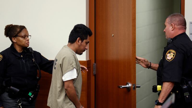 Franklin County Sherriff's deputies escort Gerson Fuentes, center, the man accused of raping a...
