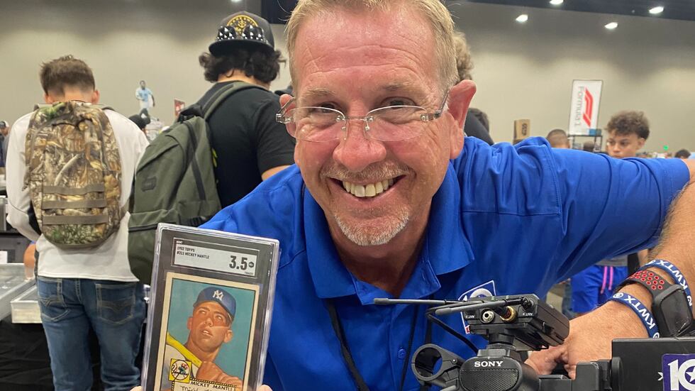 News 10 Chief Photographer Bradley Vaughn holds up a 1952 Mickey Mantle rookie card, worth...