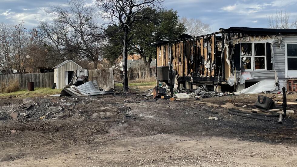 The fire destroyed the family's home and ravaged a nearby mobile home.