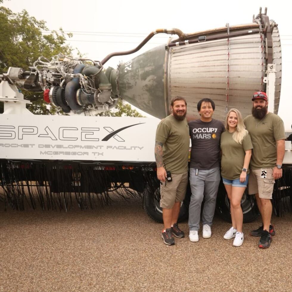 McGregor residents post next to SpaceX engine.