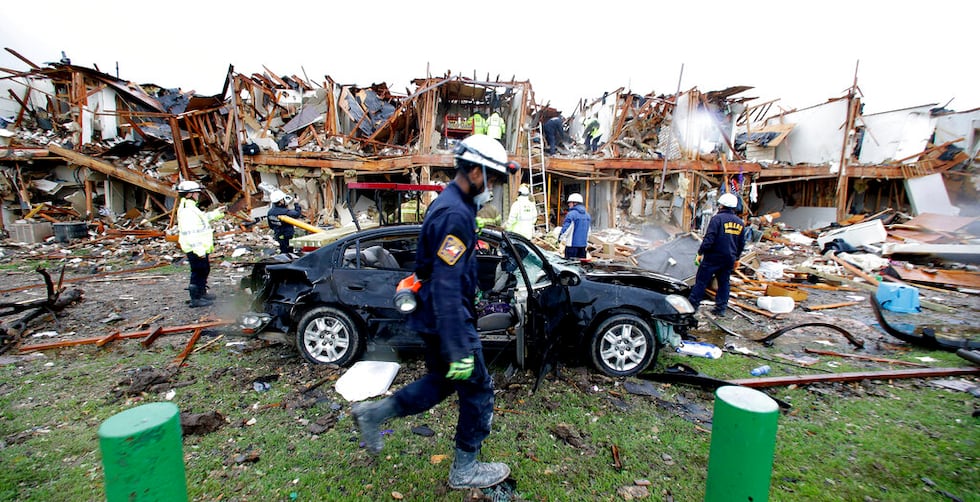 FILE - In this April 18, 2013, file photo, firefighters conduct search and rescue of an...