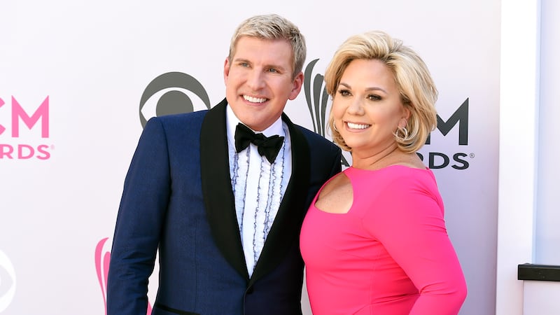 Todd Chrisley, left, and his wife, Julie Chrisley, pose for photos at the 52nd annual Academy...