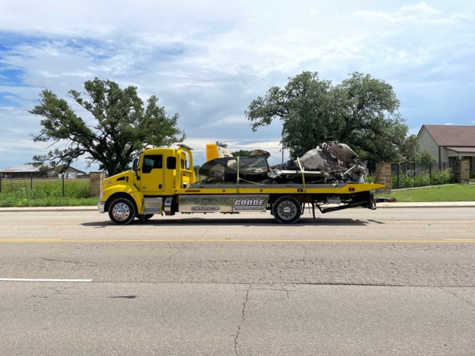 Crews removed the wreckage of the deadly plane crash from the field on Monday.