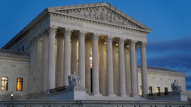 Light illuminates part of the Supreme Court building at dusk on Capitol Hill in Washington,...