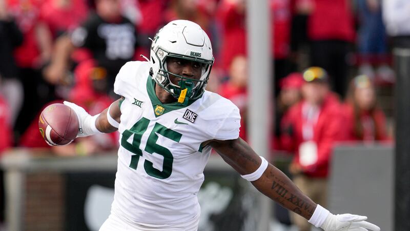 Baylor's Byron Vaughns reacts after recovering a fumble for a touchdown during the first half...