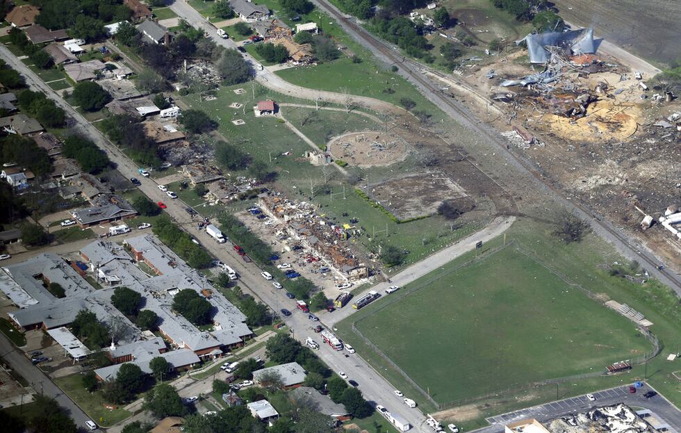 FILE - In this April 18, 2013 aerial file photo are the remains of a nursing home, left,...